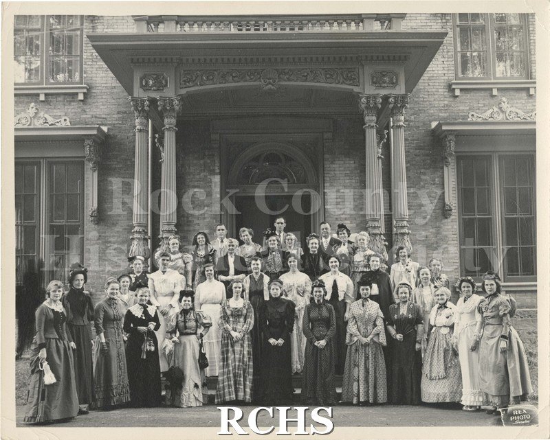 Black and white photograph of Lincoln Tallman Museum Dedication 1951. There are 33 women dressed in costumes and 3 men standing in front of the Tallman House.