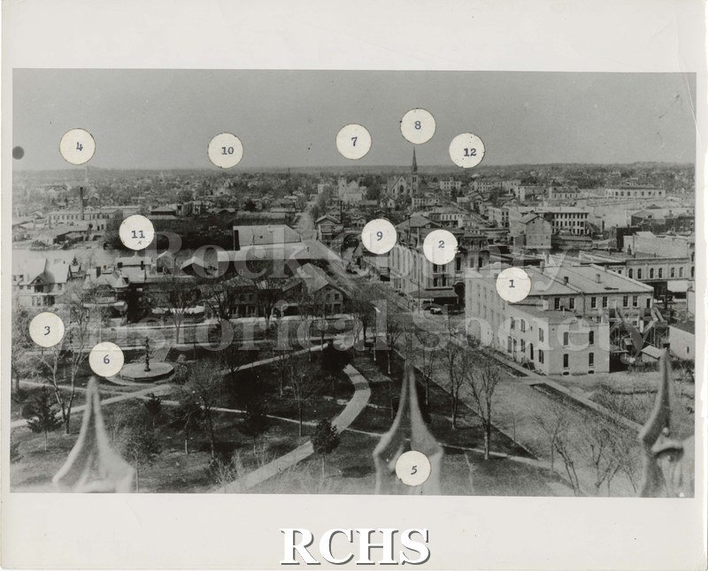 Black and white photograph of a labeled black and white image of Janesville, specifically Court Street looking west.