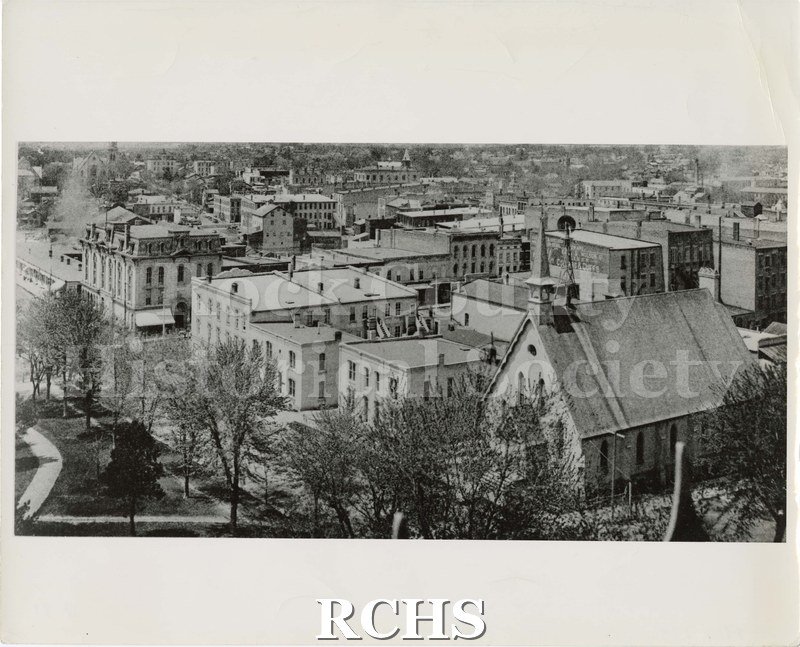 Black and white photograph of a street in Janesville.
