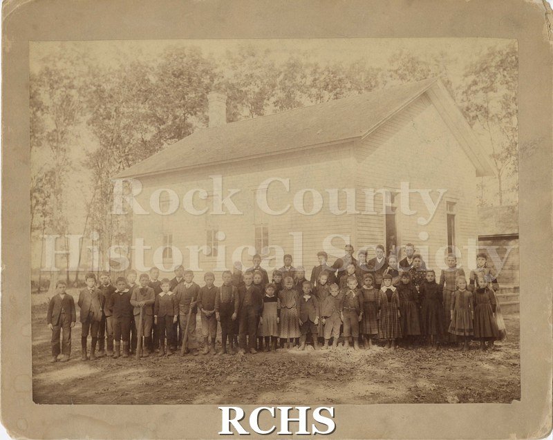 Black and white photograph of North Magnolia school children in front of a white, one-room schoolhouse, ca. 1889-1890. .