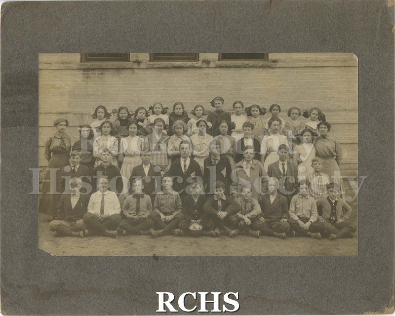 Black and white photograph of Beth Weaver's class. Shows children standing outside a building (schoolhouse?).
