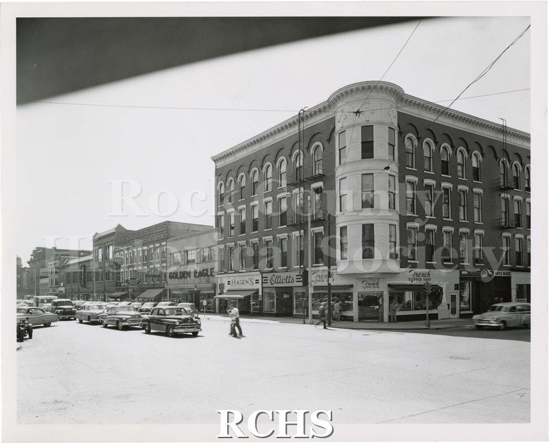 Black and white photograph of Lappin's block around 1955. Visible shops include: Golden Eagle, Hagen's, Elliotts, French Supper Shop, Diamonds C.W.