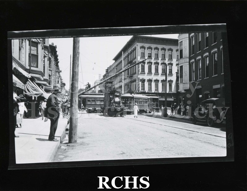 Black and white photograph of Janesville power poles. Shows men installing higher power poles c. 1925.