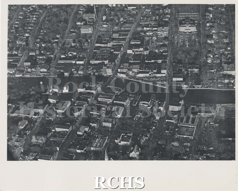 Black and white aerial photograph of the Janesville downtown, around 1960, facing Northeast.