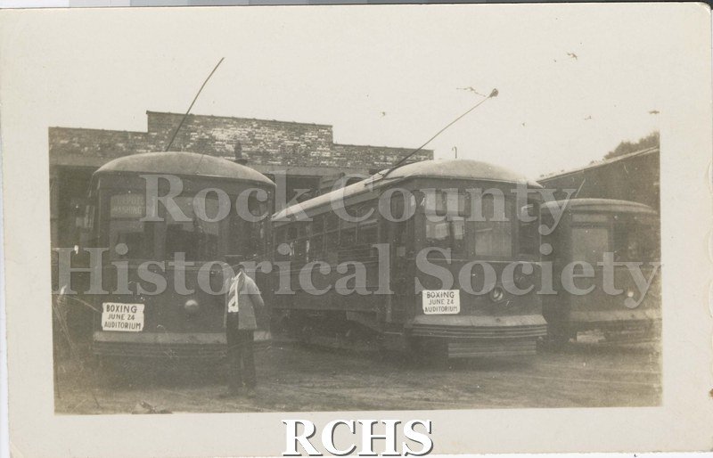 Black and white photograph of Janesville Streetcars and Barn showing three streetcars.
