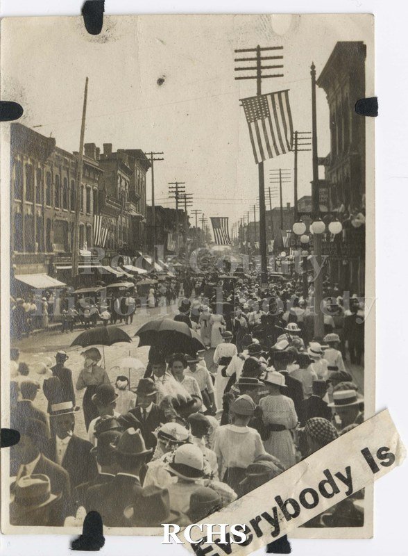 Black and white photograph of July 4 parade circa 1917 on Milwaukee Street. Shows a crowd on Milwaukee Street awaiting arrival of parade.