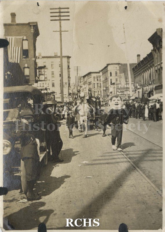 Black and white photograph of a parade on Milwaukee Street, Janesville.
