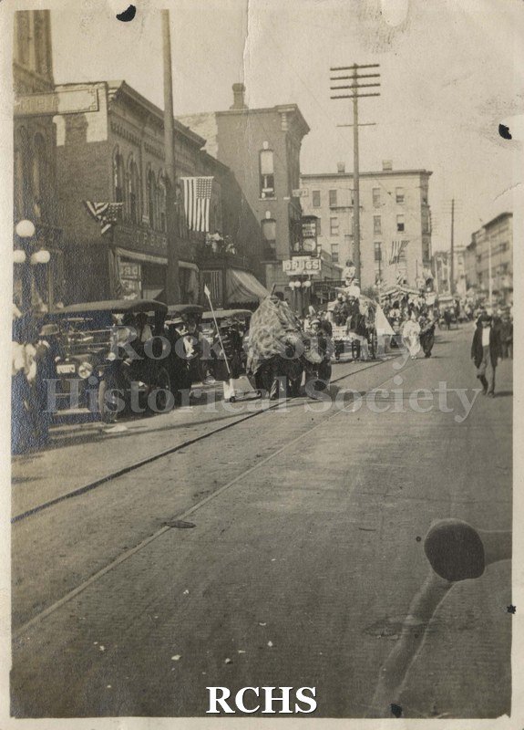 Black and white photograph of a parade on Milwaukee St., Janesville.