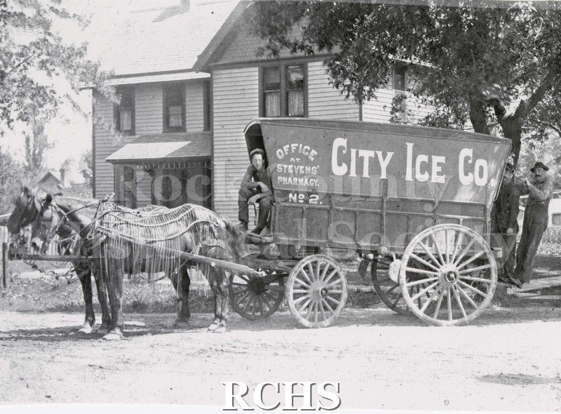 Black and white photograph of City Ice Co. team and wagon. On the side of the wagon is printed: "Office at Stevens' Pharmacy No. 2.