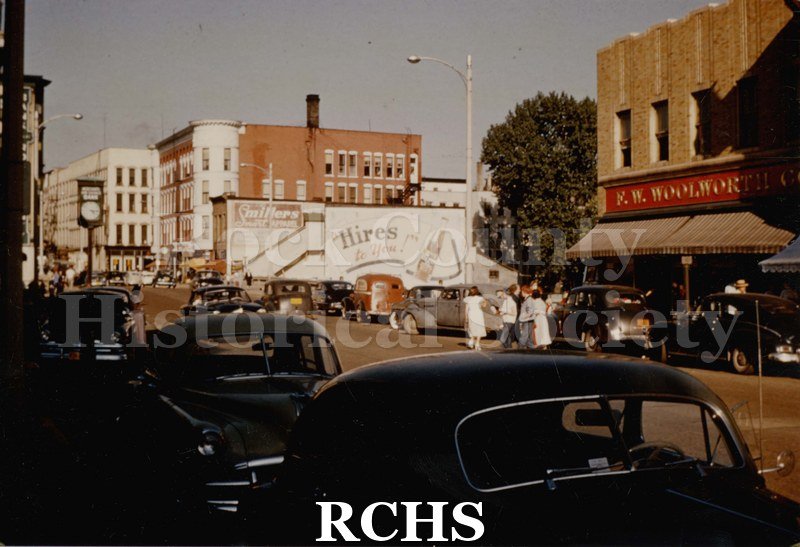 Photograph color photo of Milwaukee Street, east, and bridge with Hayes Block and Myer's Hotel in left background. Shows F. W.