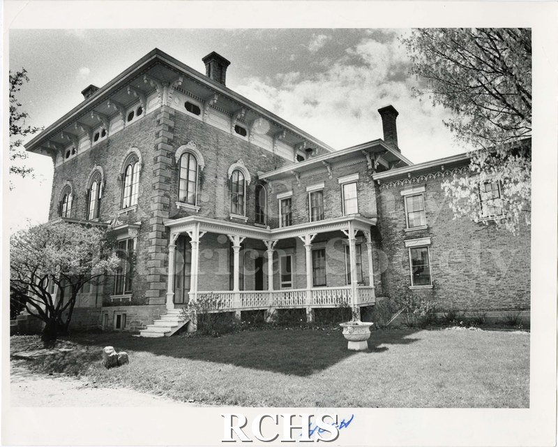 Black and white photograph of the Tallman house from the side in 1984. Porch and conservatory visible.