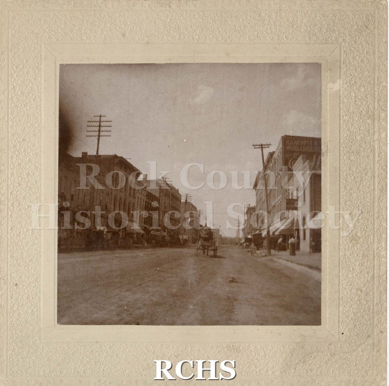 Black and white photograph of South Main Street, Janesville, WI. On back of photograph it reads: "Janesville, Wisconsin, South Main Street bt. Milwaukee and Court c.