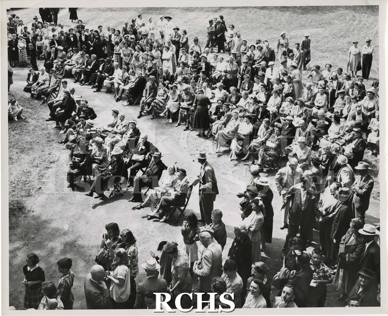 Black and white photograph of the Lincoln-Tallman Museum Dedication. Shows a crowd of people standing and sitting in chairs.
