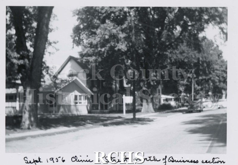 Black and white photograph of the Footville Clinic with sign in front.
