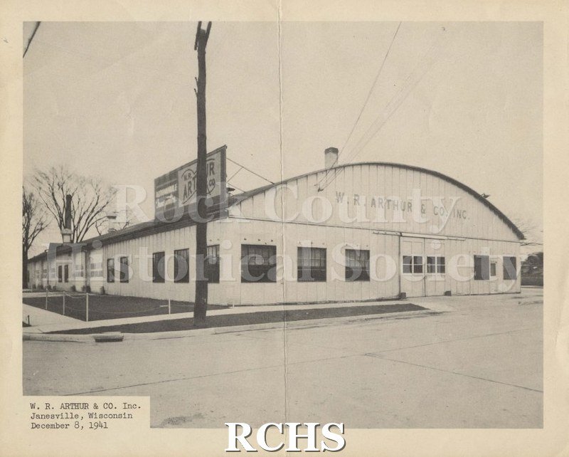Black and white photograph of W. R. Arthur Co. building. Shows a quonset hut type building with a sign reading: "W. R.
