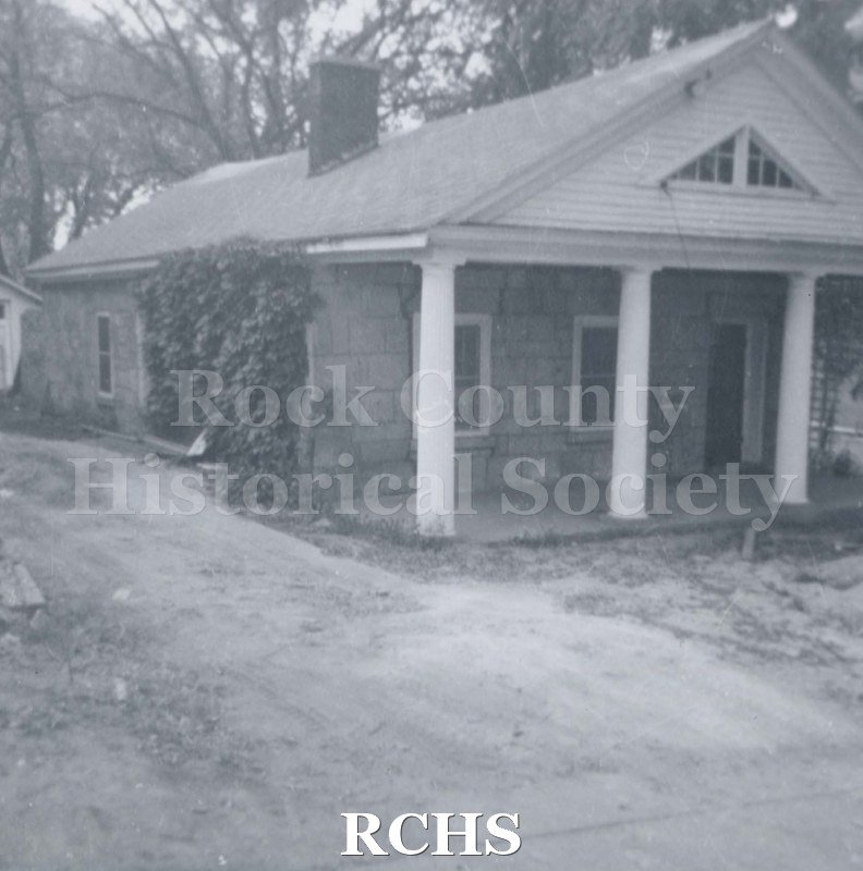 Black and white photograph of the Stone House which has been moved to the Tallman House campus.