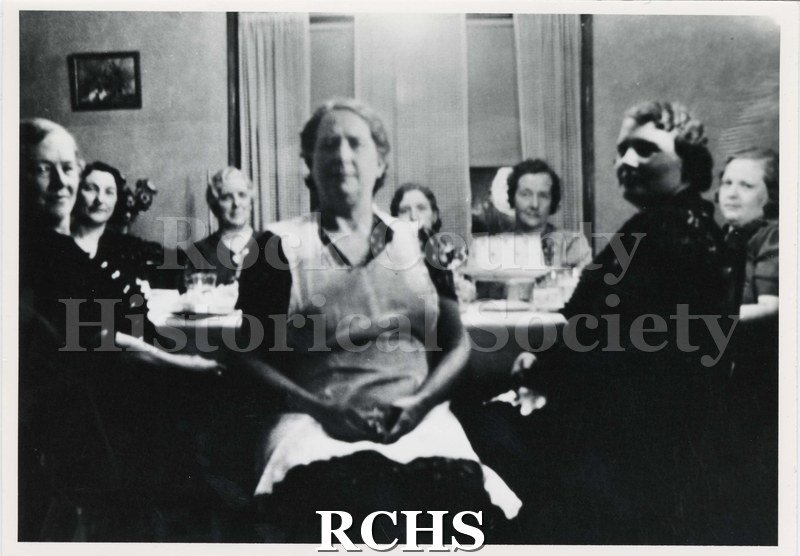 Black and white photograph of the Ladies Club 1934. Women are sitting around a table.