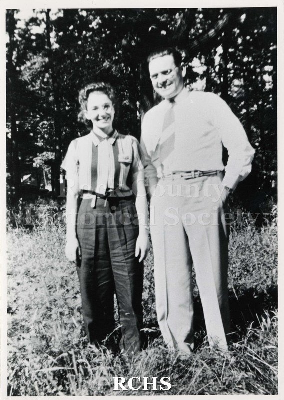 Black and white photograph of the Labor picnic 1933. Shows a man and woman standing in a field with trees in the background.