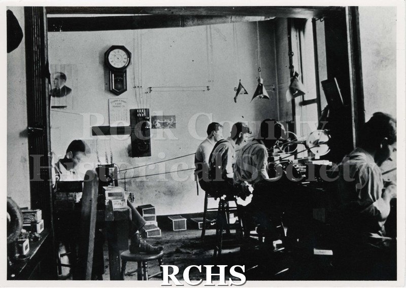 Black and white photograph of the Parker Pen factory cc. 1905. Shows men working at machines.