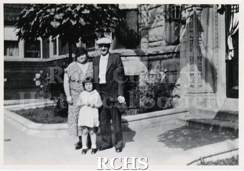 Black and white photograph of Beverly Johnson, Doris Johnson, and Harry Johnson 1933 posing in front of a building.
