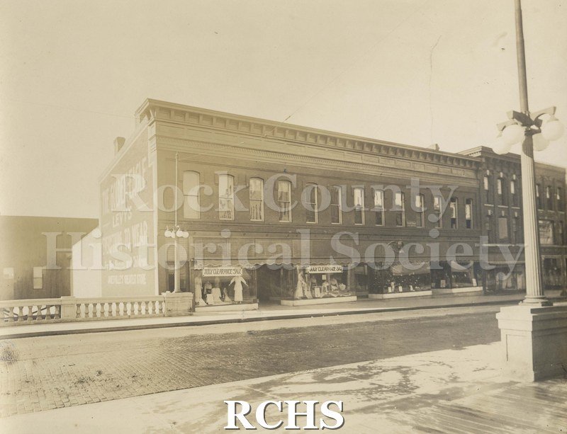 Black and white photograph of early Janesville. Shows several stores along Milwaukee Street: "Levy's".