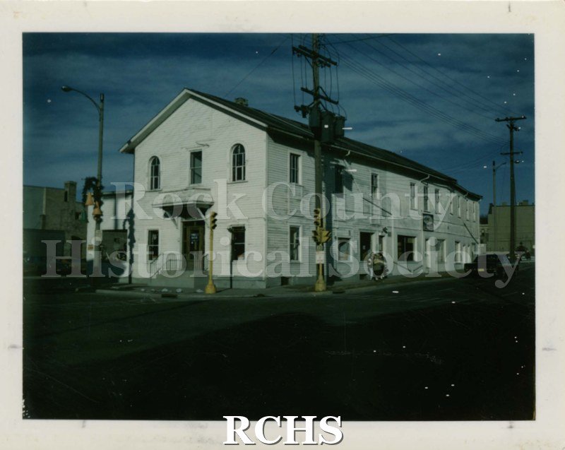 Color photo of Hope Chapel, a two story wooden building. There is a figure on the side of the building.