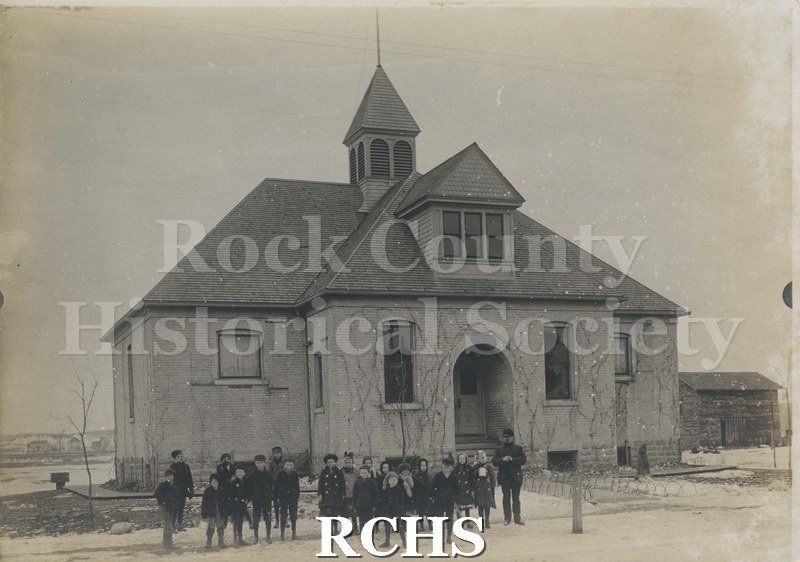 Black and white photograph of Springbrook school children standing in front of a school building.