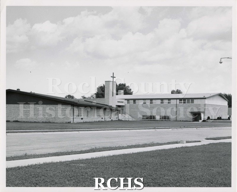 Black and white photograph of St. William's Catholic Church, c. 1955. Pictures the side of the church and fellowship hall.
