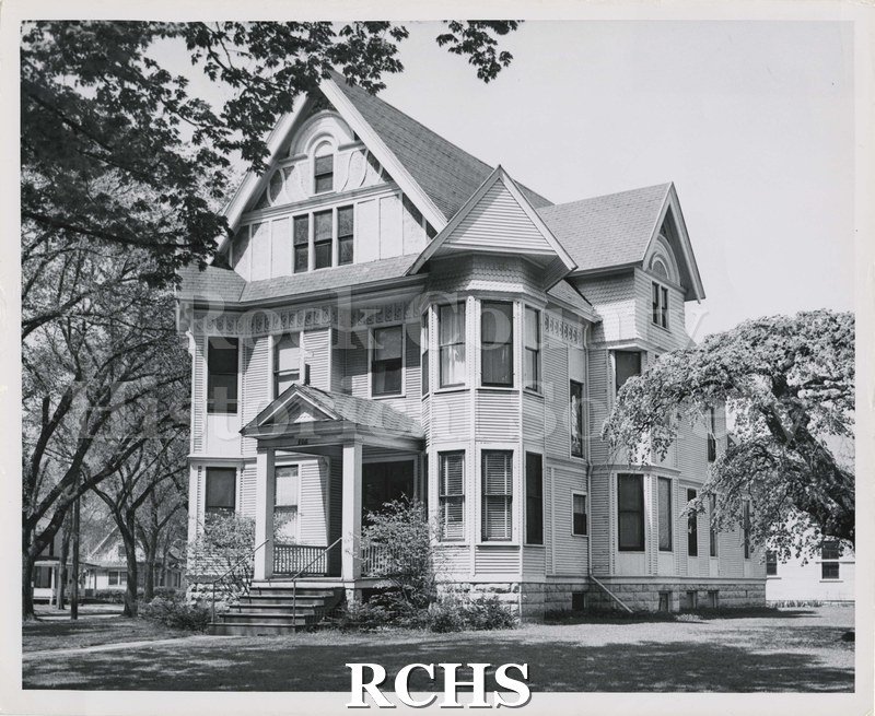 Black and white photograph of St. Matthew's Ev. Lutheran Church, Janesville, WI. Shows a three story house that is being used as a church.