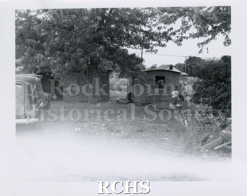 Black and white photograph of 1924 S. Grant St., Janesville, WI. Shows two small structures side by side.
