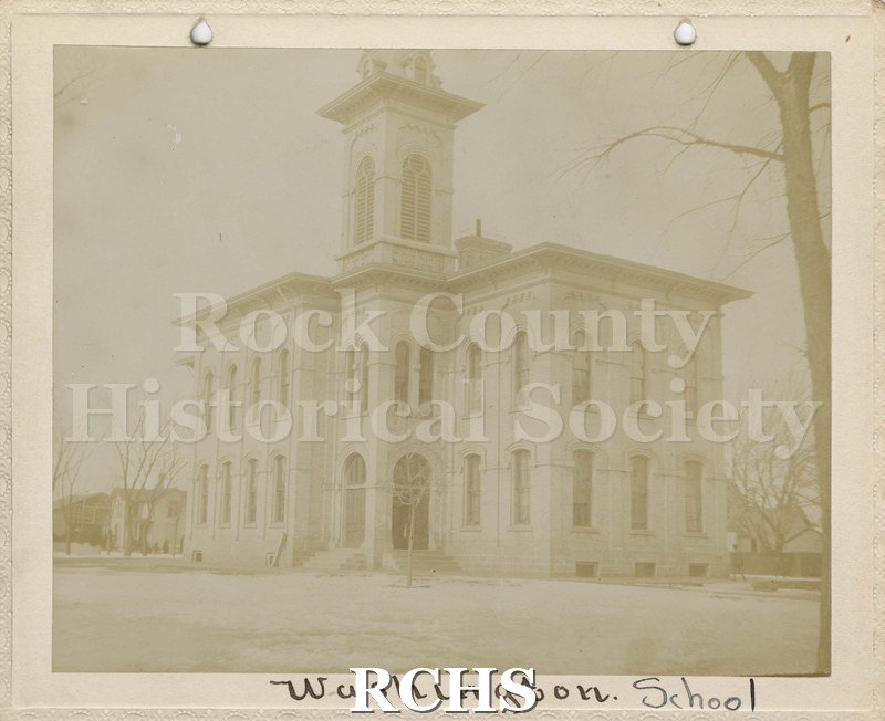 Black and white photograph of Washington School, Janesville, WI, a two story brick building with a tower on top. On bottom: "Washington School".