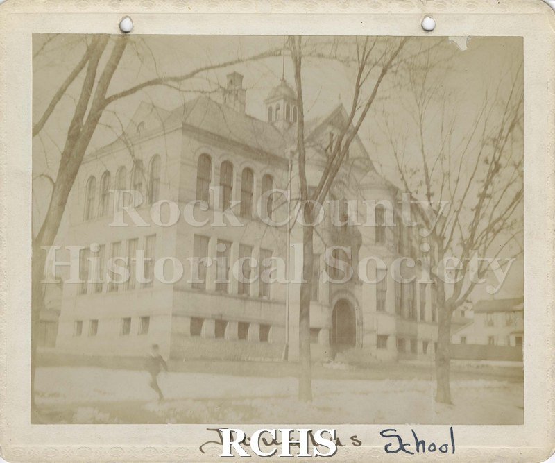 Black and white photograph of Douglas School, Janesville, WI, a three story brick building with a cupola on top. On bottom: "Douglas School".