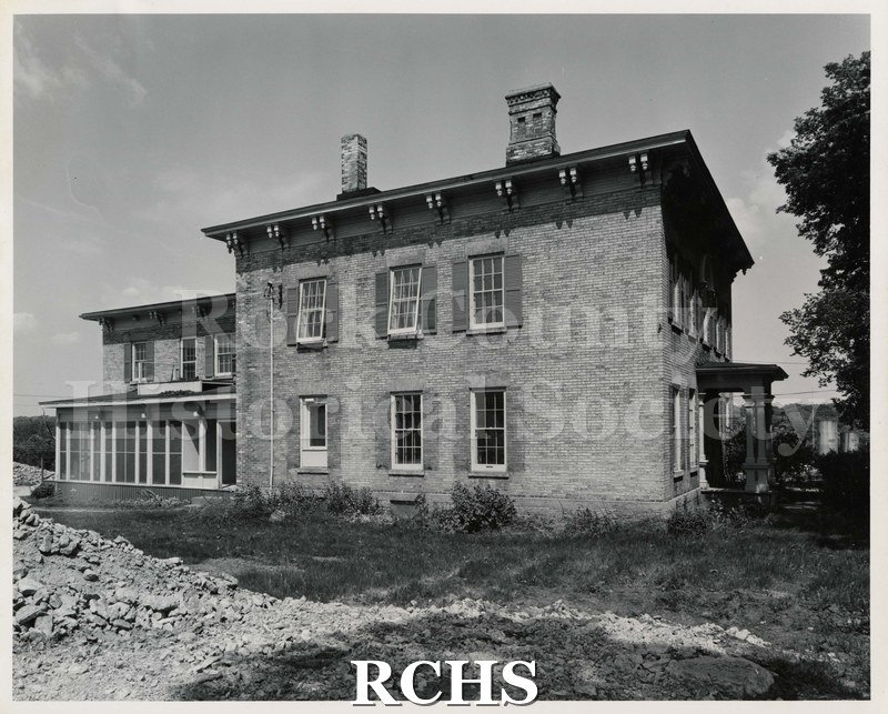 Black and white photograph of the demolition of Wright-Amato House. Shows a two story house with debris on the left side.