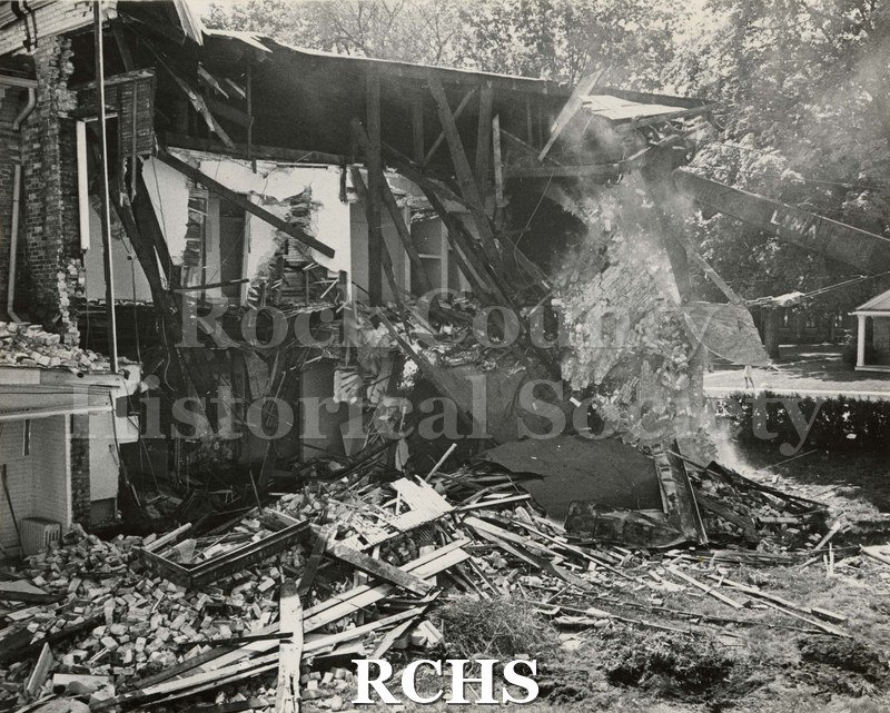 Black and white photograph of "Wright-Amato House. Shows the demolition of a builidng with debris in front.