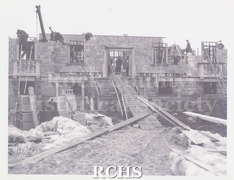 Black and white photograph of Janesville Sand and Gravel Co. construction site. Construction of concrete block building.