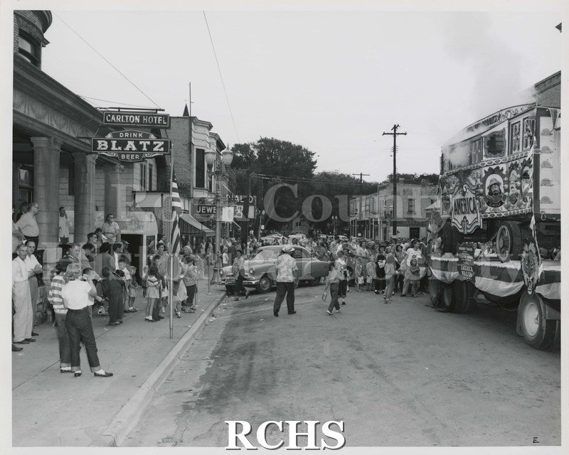 Black and white photograph of a circus wagon on a flat bed truck.