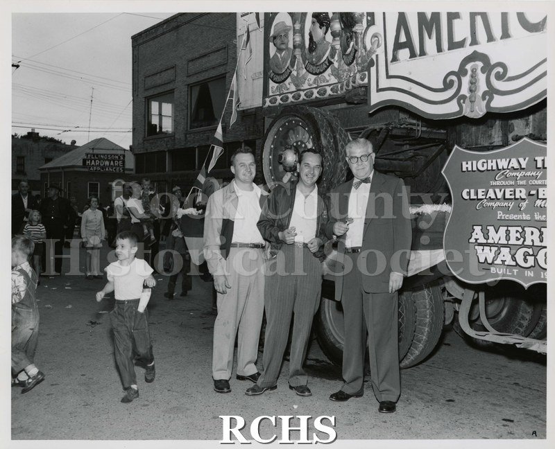 Black and white photograph of a circus wagon on a flat bed truck.