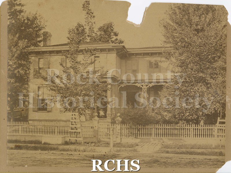 Black and white photograph of Judge Amos P. Prichard's Home, a two story house almost hdden by trees.