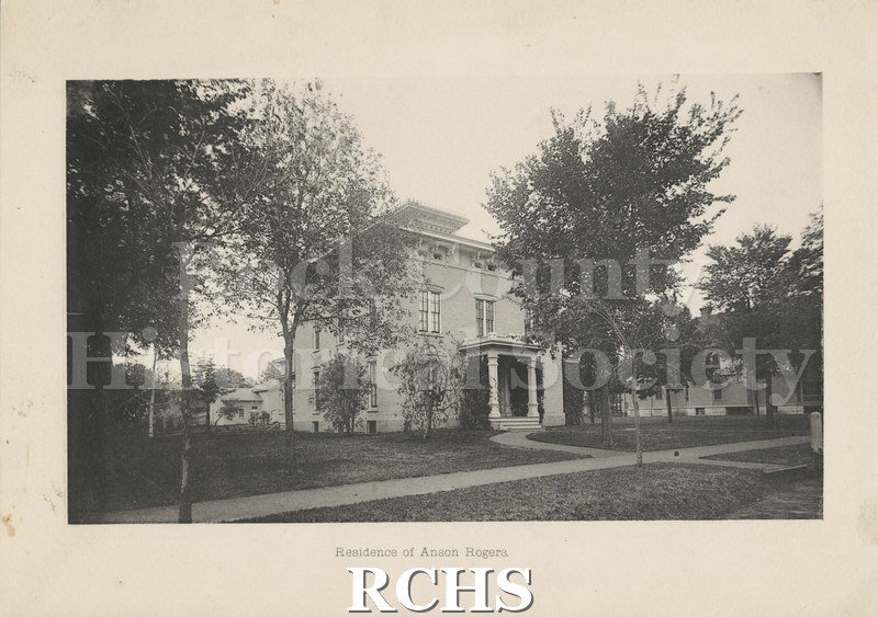 Black and white photograph of the residence of Anson Rogers. Shows a two story house with trees in front. On bottom: "Residence of Anson Rogers".
