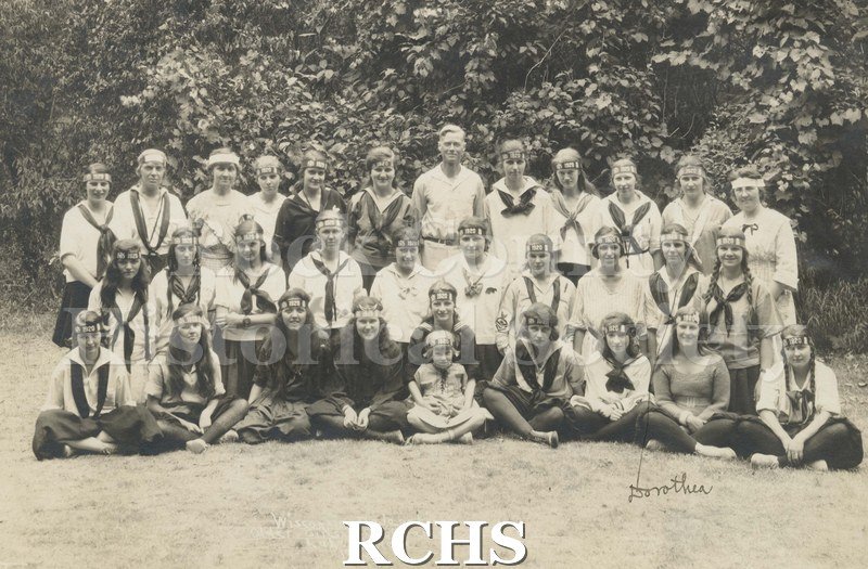 Black and white photograph of the Wisconsin Sunday School Association. Shows a group of people standing and sitting with trees in the background.
