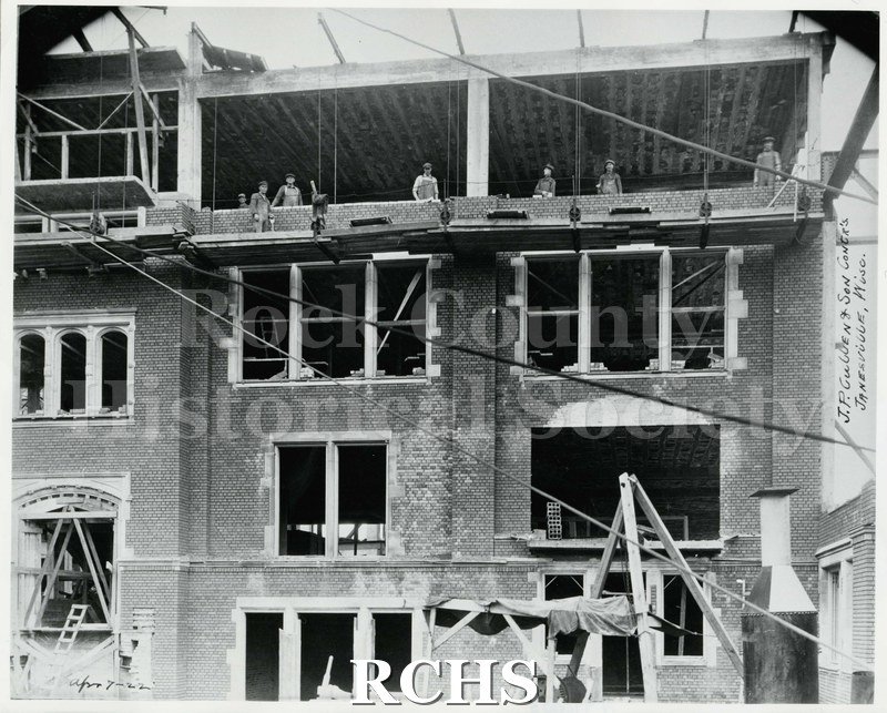 Black and white photograph of the construction site for Janesville High School, dated April 7, 1922. Written on photo: " J.P. Cullen & Son Contr's Janesville, Wisc.".