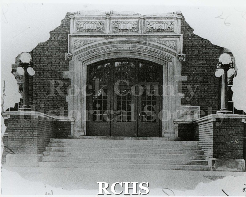 Black and white photograph of the main entrance to Janesville High School. Written on reverse: "1926 Phoenix - (Front)".