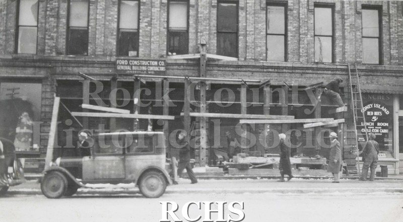 Black and white photograph of Kroger Store 1934. Pictured is a building under construction. There is a sign above the storefront that reads: "Ford Construction Co.