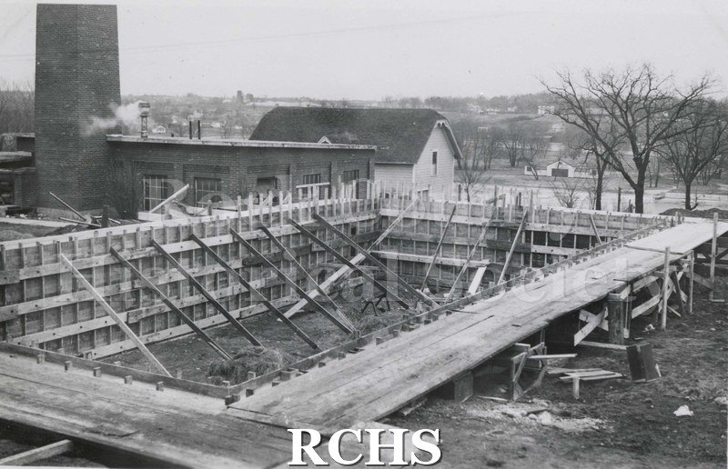 Black and white photograph of Mercy Hospital Laundry Addition 1941 under construction. The framework is up and there are braces holding up the walls.