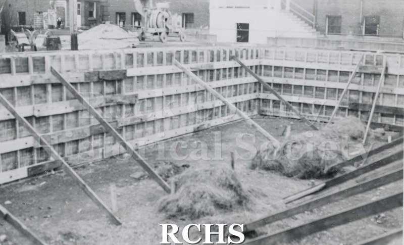 Black and white photograph of Mercy Hospital Laundry Addition 1941 under construction. The framework is up and there are braces holding up the walls.
