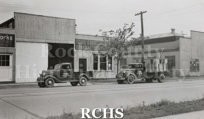 Black and white photograph of Ford Construction Co. 1938. Pictured is a building with the sign: "Ford Construction General Contractors" above the window.