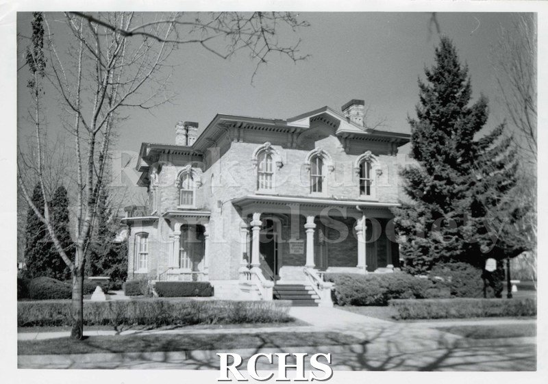 Black and white photograph of Durkee-Tallman-Henning House, showing front of a two story home with a pillared porch.