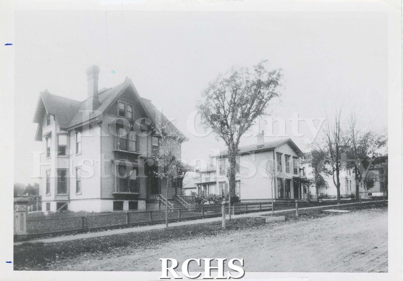 Black and white photograph of 415 N. Jackson Street, a three story house on the left, and a two story house on the right.