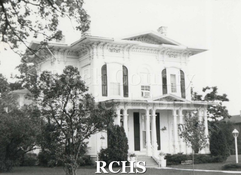 Black and white photograph of 404 St. Lawrence, a two story house with pillared porch.