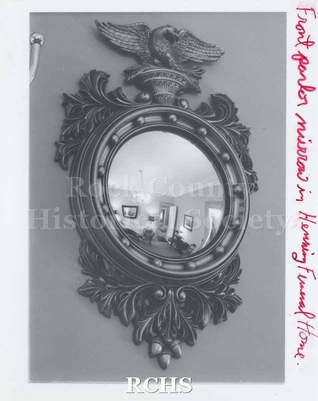 Black and white photograph of the front parlor mirror in Henning Funeral Home On side: "Front parlor mirror in Henning Funeral Home".